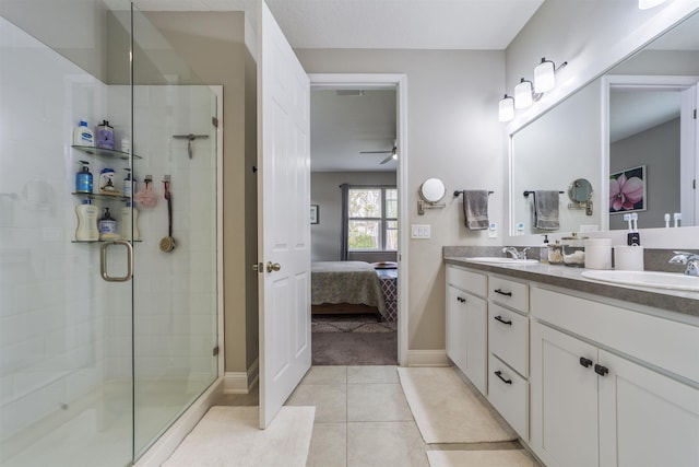 bathroom featuring tile patterned floors, ceiling fan, vanity, and an enclosed shower