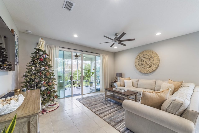 living room with ceiling fan and light tile patterned flooring