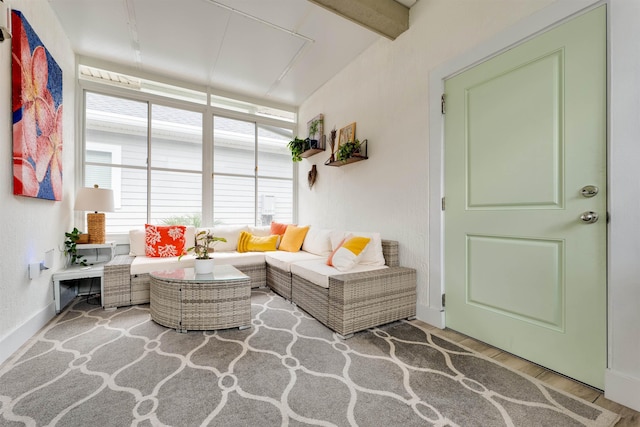 living room featuring wood-type flooring and beam ceiling