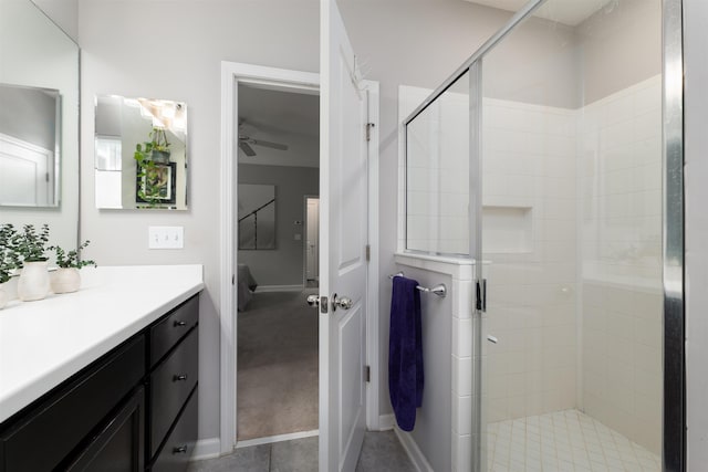 bathroom with vanity, ceiling fan, and a shower with door