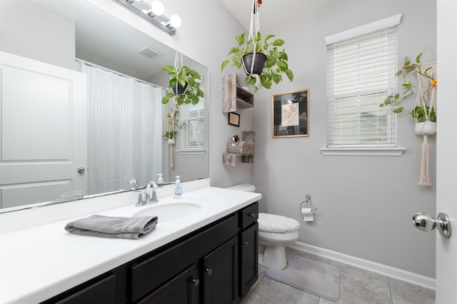 bathroom with tile patterned flooring, vanity, and toilet