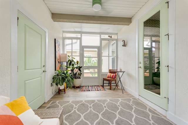 sunroom with beamed ceiling