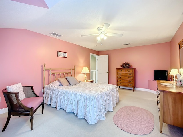 bedroom with ceiling fan, light colored carpet, and lofted ceiling