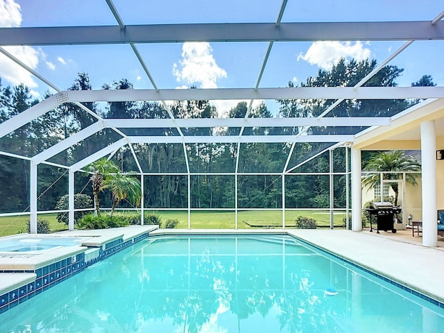 view of pool with glass enclosure, a patio area, an in ground hot tub, and grilling area