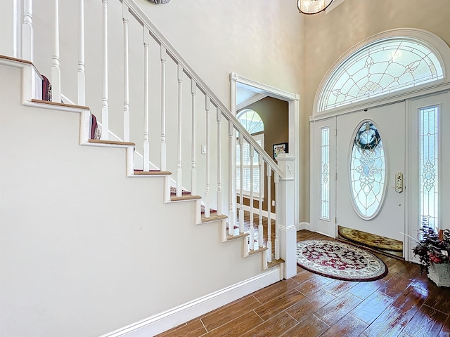 foyer entrance featuring plenty of natural light and dark hardwood / wood-style floors