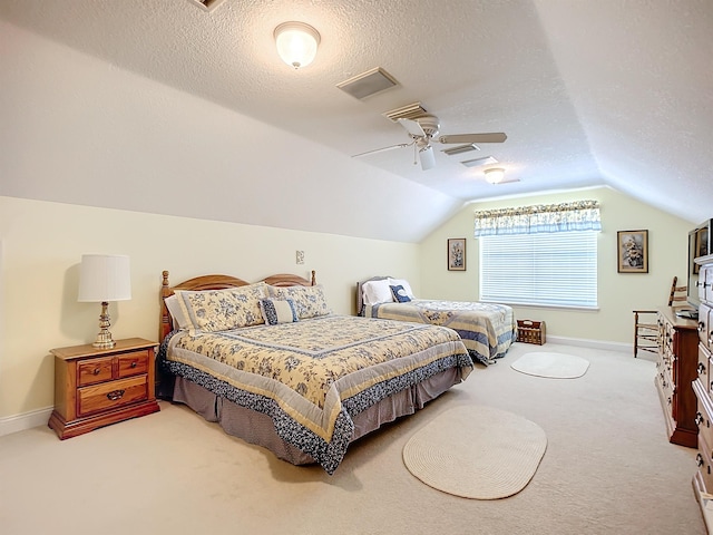 carpeted bedroom with a textured ceiling, ceiling fan, and lofted ceiling