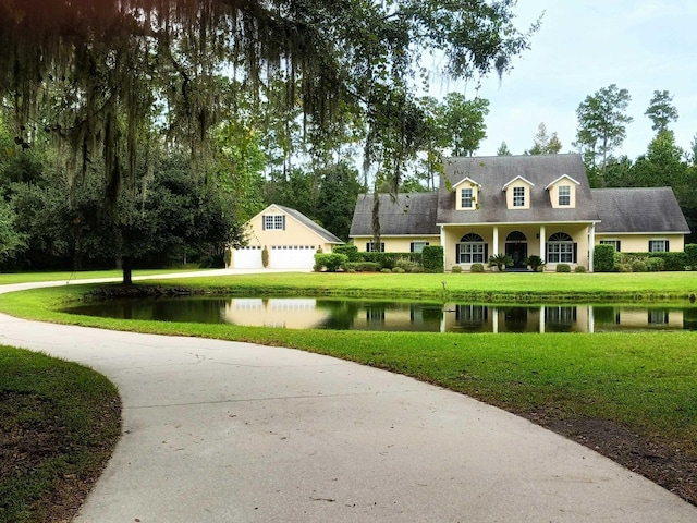 view of community with a yard and a water view