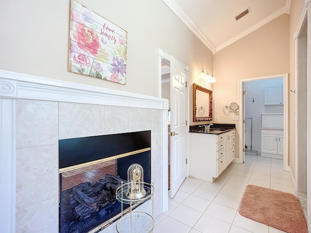 bathroom with tile patterned floors, vanity, ornamental molding, and high vaulted ceiling