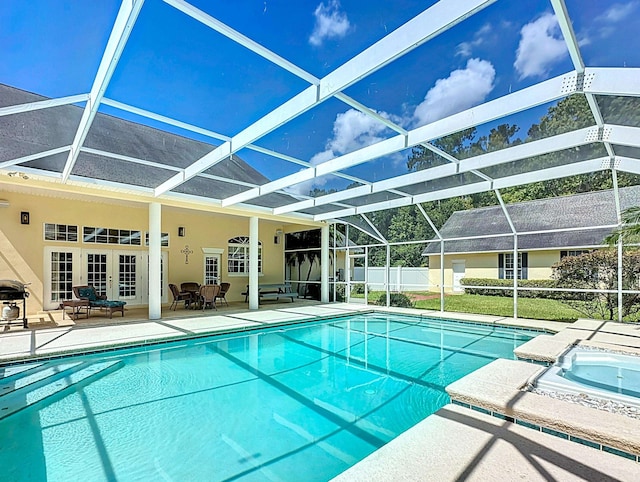 view of swimming pool with an in ground hot tub, french doors, glass enclosure, grilling area, and a patio