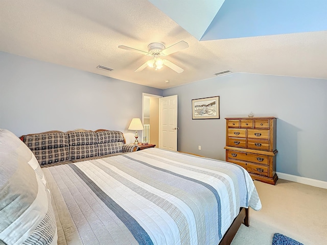 carpeted bedroom with a textured ceiling, ceiling fan, and lofted ceiling