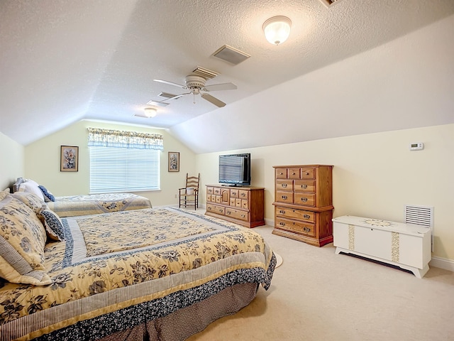 carpeted bedroom featuring a textured ceiling, vaulted ceiling, and ceiling fan