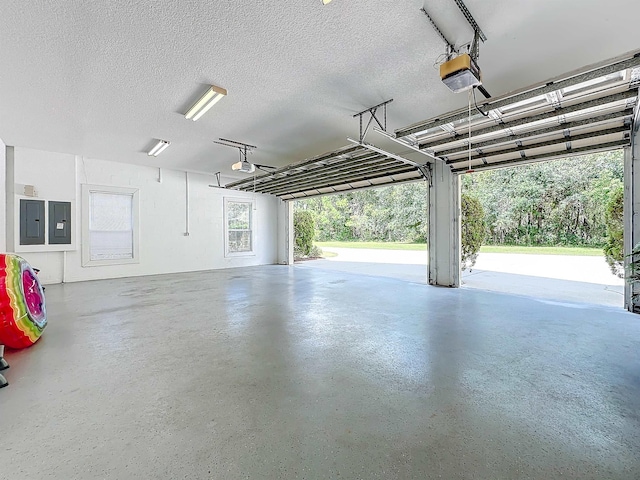 garage featuring electric panel and a garage door opener