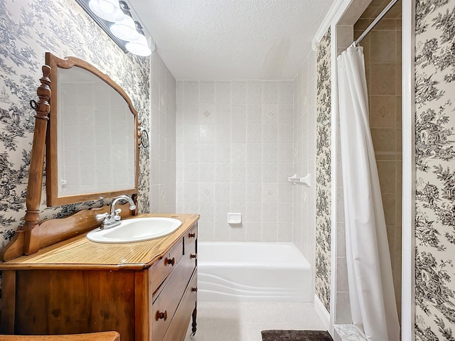 bathroom featuring tile patterned flooring, vanity, and a textured ceiling