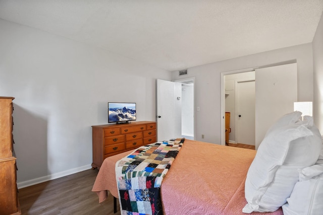 bedroom featuring dark hardwood / wood-style flooring