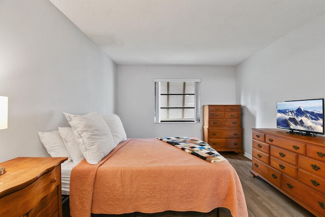 bedroom with dark hardwood / wood-style floors