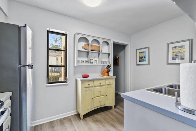 kitchen with stainless steel fridge and light wood-type flooring