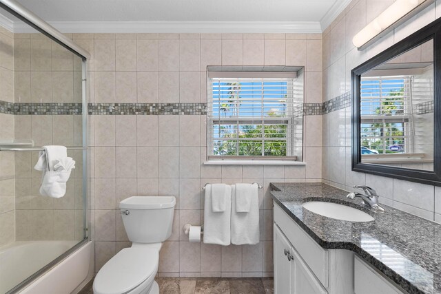 12 13th St, Saint Augustine Beach, FL 32080 - kitchen featuring a sink, island range hood, ornamental molding, brown cabinetry, and light tile patterned floors