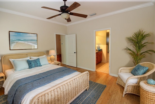 bedroom featuring light wood-type flooring, ceiling fan, ornamental molding, and connected bathroom