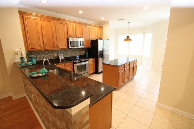 kitchen with stainless steel appliances, tasteful backsplash, kitchen peninsula, crown molding, and dark stone countertops