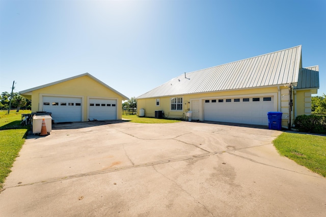 view of front of property featuring central AC and a garage