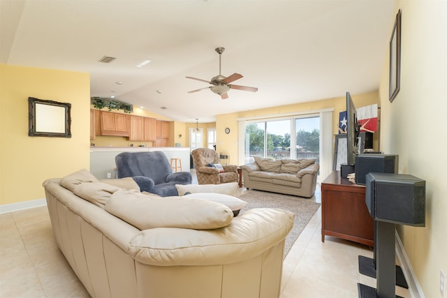 living room with ceiling fan, light tile patterned floors, and vaulted ceiling