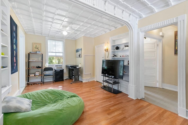 living room with hardwood / wood-style floors and built in shelves