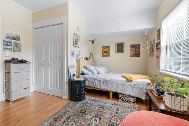 bedroom featuring light wood-type flooring and a closet