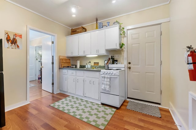 kitchen with crown molding, white cabinets, light hardwood / wood-style floors, and white electric stove