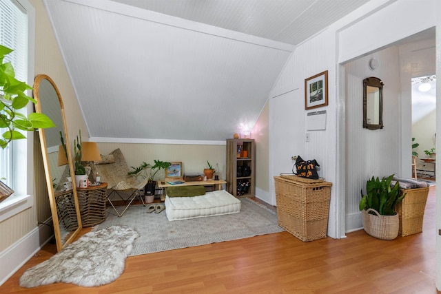 living area with hardwood / wood-style floors and vaulted ceiling