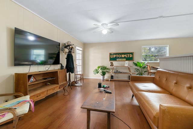 living room with hardwood / wood-style floors, ceiling fan, and a healthy amount of sunlight