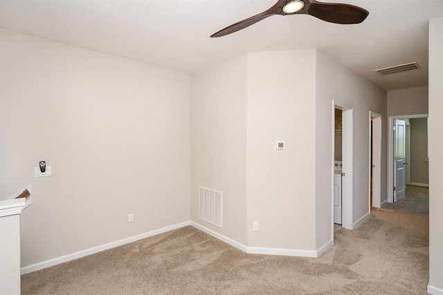 carpeted spare room featuring ceiling fan