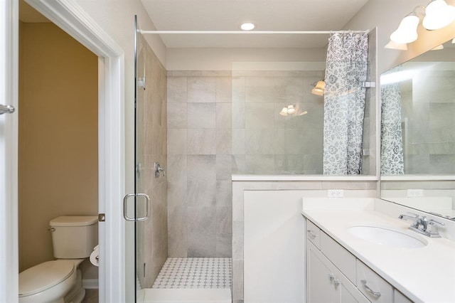 bathroom featuring vanity, toilet, and a shower with shower curtain