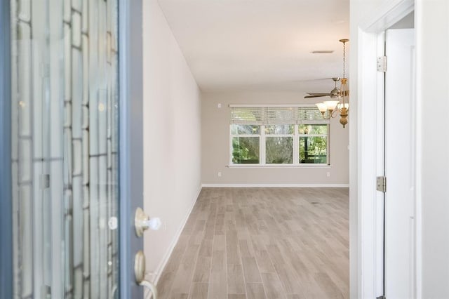 foyer entrance featuring lofted ceiling and light wood-type flooring