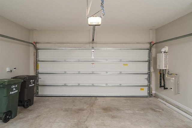 garage with a garage door opener and water heater