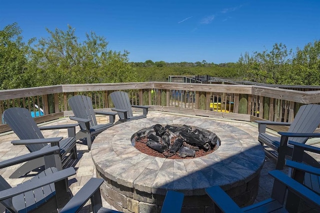 deck featuring a patio area and a fire pit