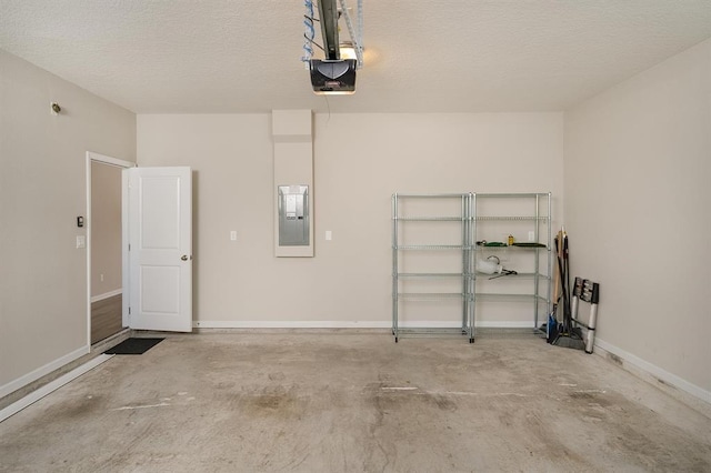 garage with a garage door opener and electric panel