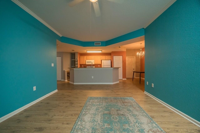 unfurnished living room featuring crown molding, ceiling fan with notable chandelier, and light hardwood / wood-style floors