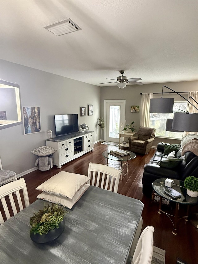 dining area featuring dark wood-type flooring and ceiling fan