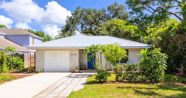 408 B St, Saint Augustine, FL 32080 - view of front of home featuring stucco siding, an attached garage, concrete driveway, and a metal roof