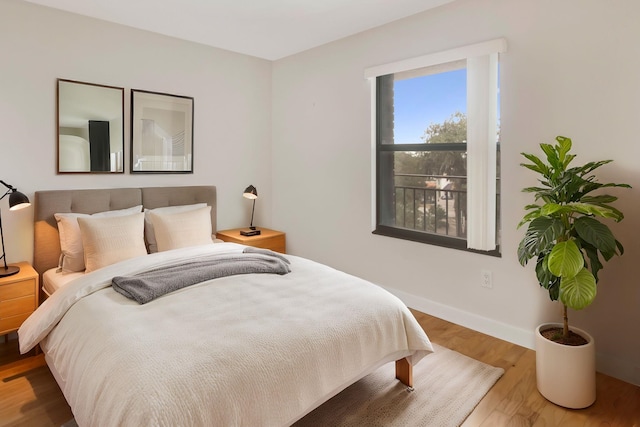 bedroom with hardwood / wood-style flooring