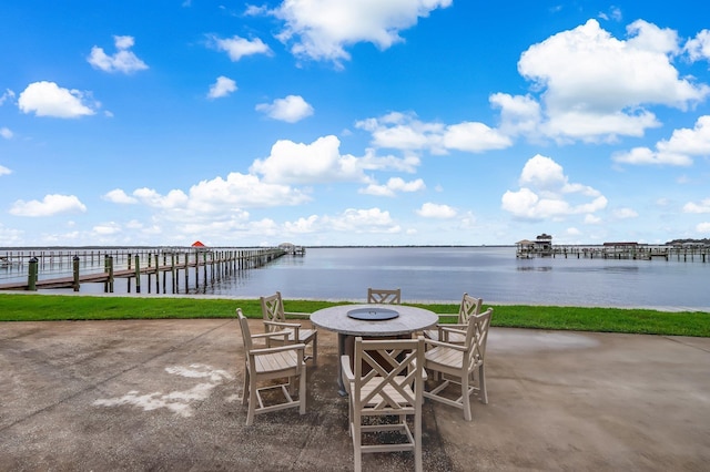 view of patio featuring a water view and an outdoor fire pit