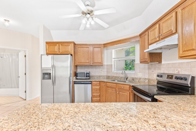 kitchen with stainless steel appliances, tasteful backsplash, sink, ceiling fan, and light tile patterned floors