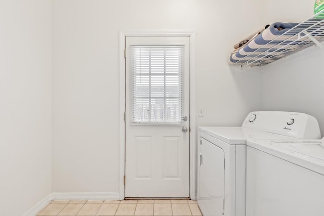 laundry area featuring washer and dryer and light tile patterned floors