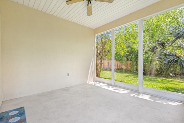 spare room featuring ceiling fan and concrete floors