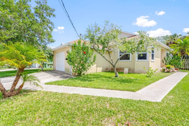 view of front of property with a front yard and a garage