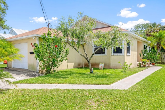 view of property exterior featuring a garage and a lawn