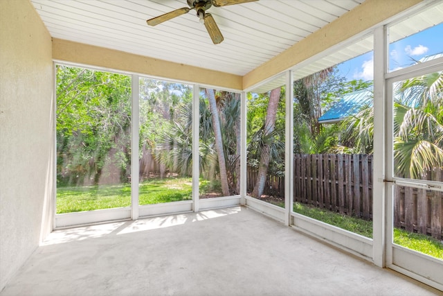 unfurnished sunroom featuring ceiling fan and a healthy amount of sunlight