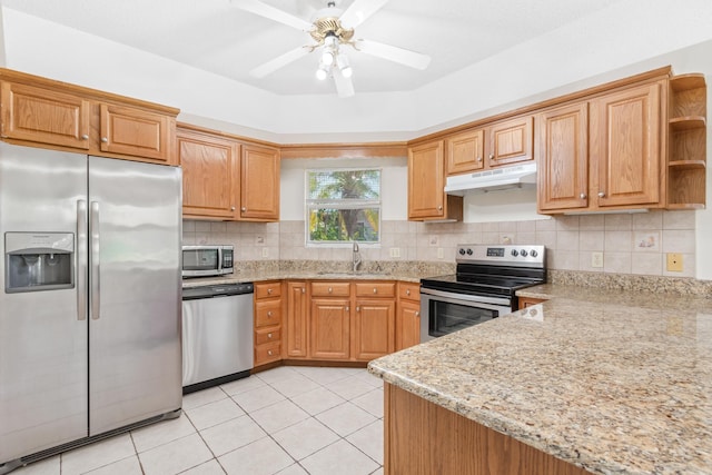 kitchen featuring ceiling fan, sink, light tile patterned flooring, light stone countertops, and stainless steel appliances