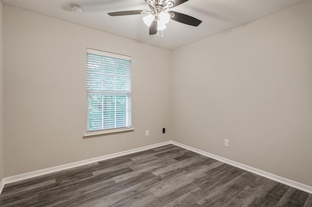 spare room featuring dark hardwood / wood-style flooring, a textured ceiling, and ceiling fan