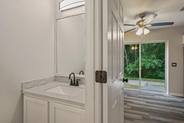 bathroom featuring hardwood / wood-style floors, vanity, a wealth of natural light, and ceiling fan